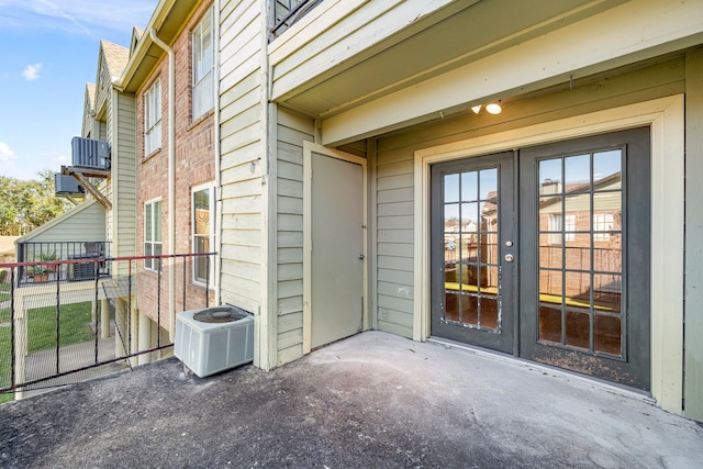 doorway to property with a patio area, central AC, and french doors