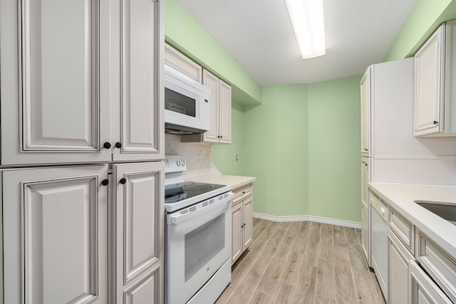 kitchen with light hardwood / wood-style floors, white appliances, backsplash, and white cabinetry