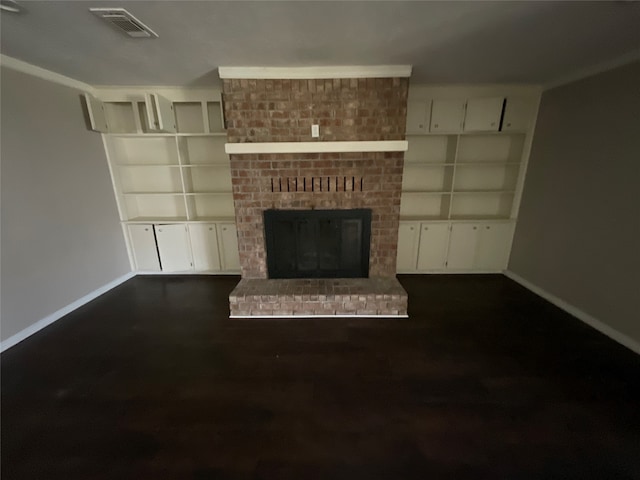 unfurnished living room featuring dark hardwood / wood-style flooring and a brick fireplace