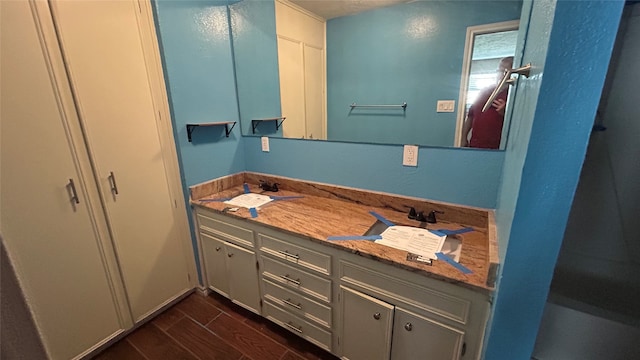 bathroom featuring hardwood / wood-style flooring and vanity