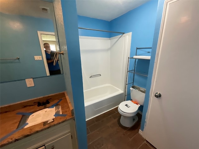 bathroom featuring bathing tub / shower combination, wood-type flooring, and toilet