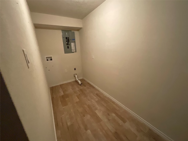 washroom with hookup for a gas dryer, hookup for a washing machine, electric panel, and light hardwood / wood-style flooring