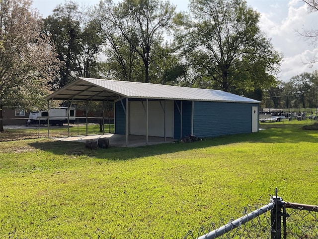 view of outdoor structure featuring a yard and a carport