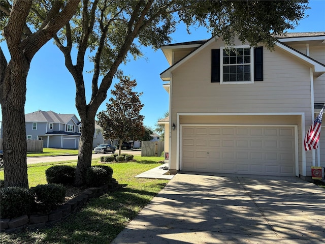 view of home's exterior featuring driveway, a residential view, an attached garage, fence, and a yard