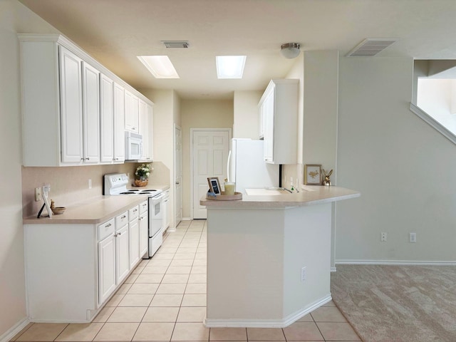 kitchen featuring light countertops, white appliances, visible vents, and white cabinets