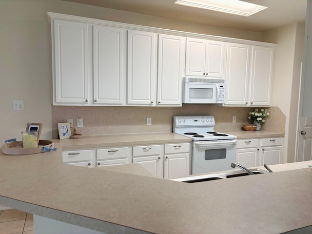 kitchen featuring a sink, white appliances, white cabinets, and light countertops