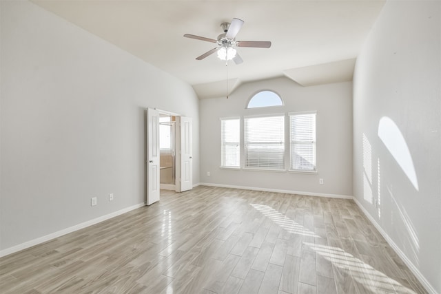 unfurnished room with ceiling fan, light wood-type flooring, and vaulted ceiling