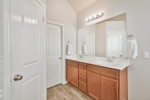 bathroom with hardwood / wood-style floors and vanity