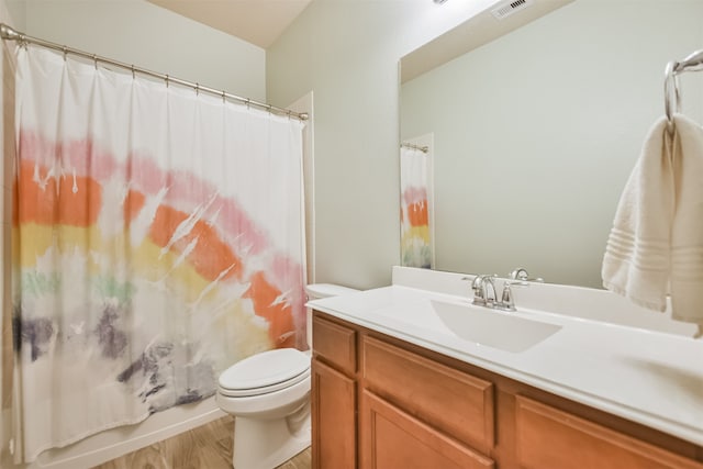 bathroom featuring hardwood / wood-style flooring, vanity, and toilet