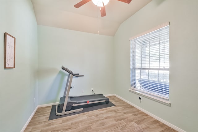 exercise area featuring lofted ceiling, light wood-type flooring, ceiling fan, and a healthy amount of sunlight