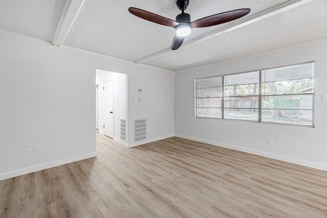 empty room with a textured ceiling, ceiling fan, light wood-type flooring, and beamed ceiling