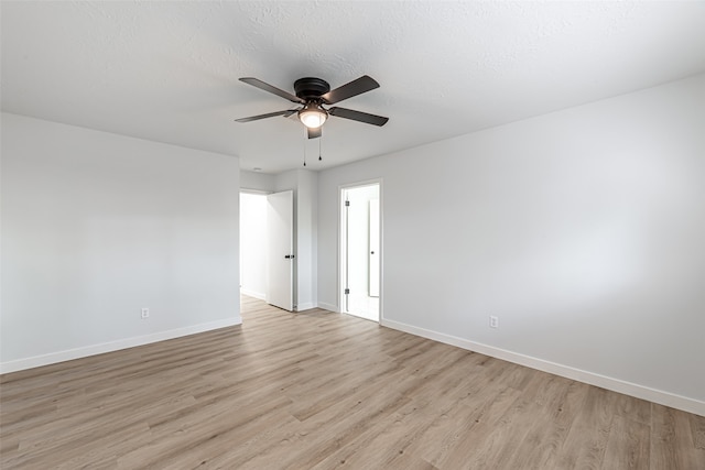 unfurnished room with light hardwood / wood-style floors, ceiling fan, and a textured ceiling