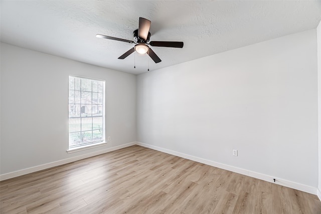 spare room with a textured ceiling, ceiling fan, and light hardwood / wood-style flooring