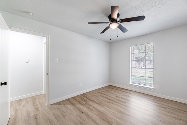 empty room featuring a textured ceiling, ceiling fan, and light hardwood / wood-style floors