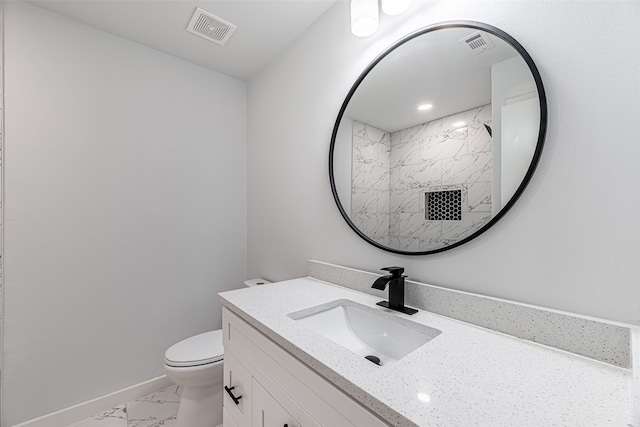 bathroom with toilet, walk in shower, and vanity