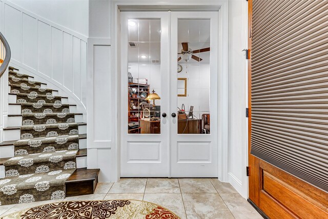 wine area with french doors, ceiling fan, and light tile patterned floors