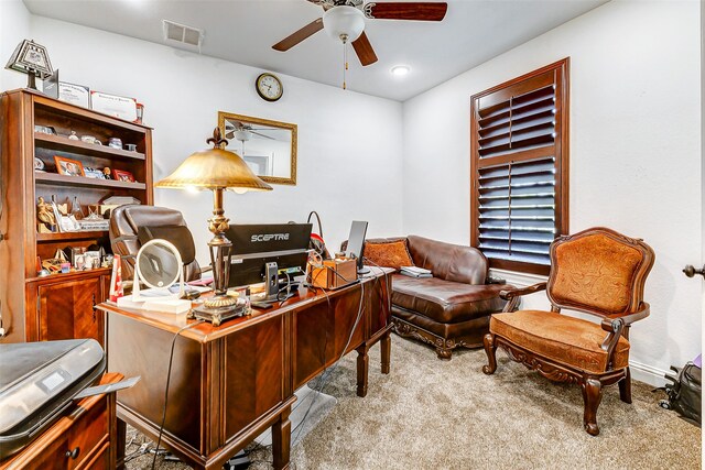 carpeted office space featuring ceiling fan