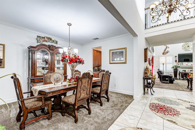 dining space featuring crown molding, an inviting chandelier, and light tile patterned floors