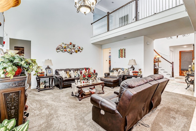 tiled living room with a towering ceiling and a chandelier