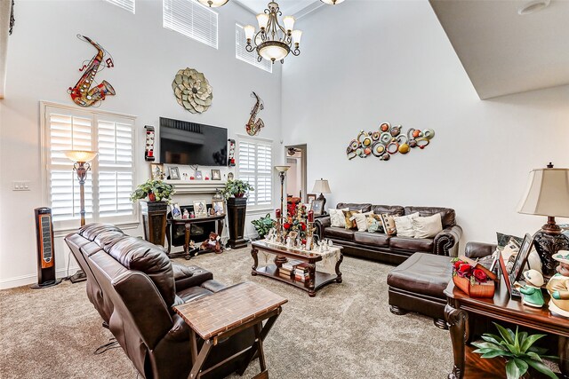 living room featuring a towering ceiling, carpet, a healthy amount of sunlight, and a notable chandelier