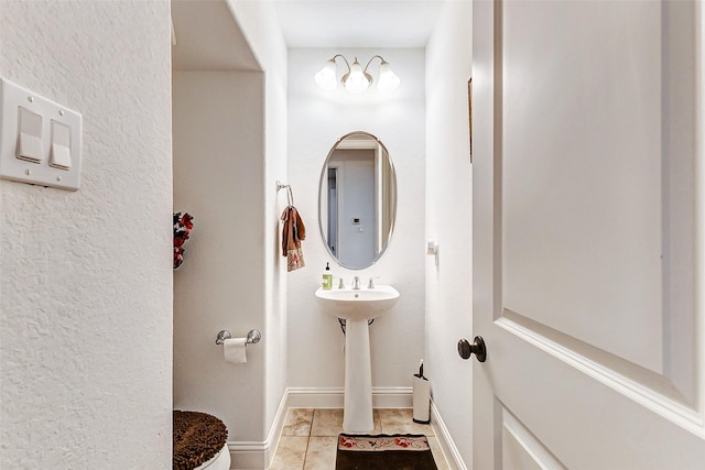 bathroom featuring toilet and tile patterned flooring