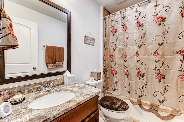 full bathroom featuring toilet, shower / bath combination with curtain, and vanity