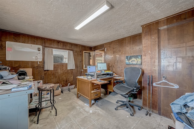 office space with wood walls and a textured ceiling