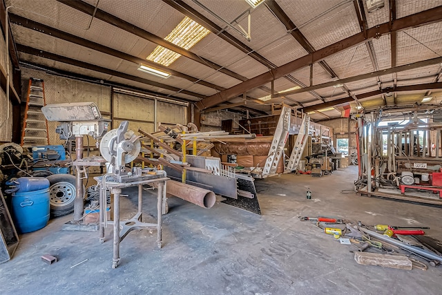 misc room with a workshop area and concrete flooring