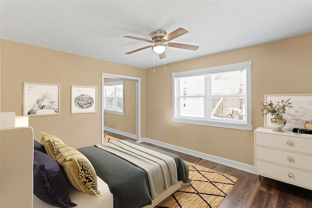 bedroom featuring ceiling fan and dark wood-type flooring