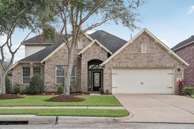 view of front facade featuring a garage and a front lawn