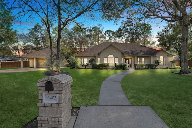 view of front facade with a yard and a garage