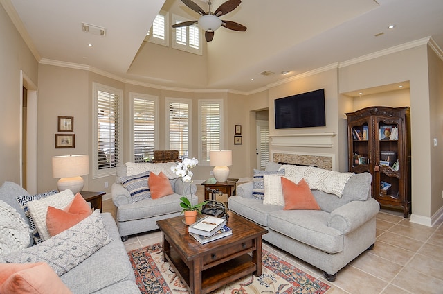 living room featuring ceiling fan, light tile patterned flooring, and a healthy amount of sunlight