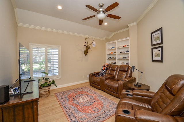 living room featuring ceiling fan, light hardwood / wood-style floors, and crown molding