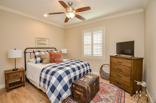 bedroom with light hardwood / wood-style flooring, ceiling fan, and crown molding