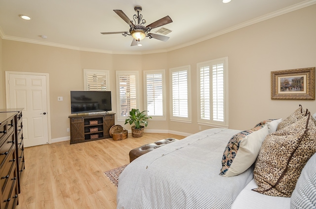 bedroom featuring ceiling fan, light hardwood / wood-style floors, and ornamental molding