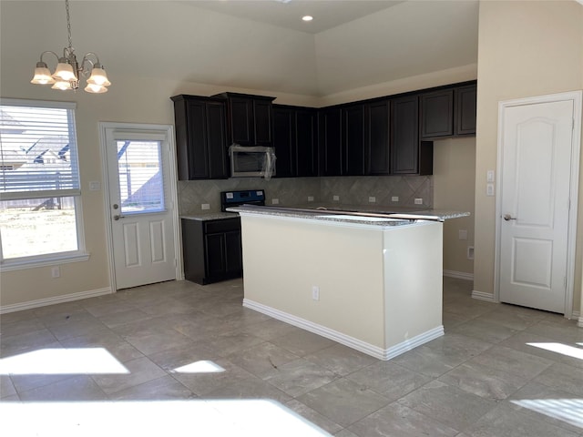 kitchen with pendant lighting, a center island, backsplash, an inviting chandelier, and black range with electric cooktop