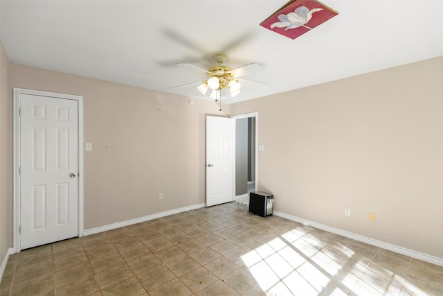 tiled empty room with ceiling fan