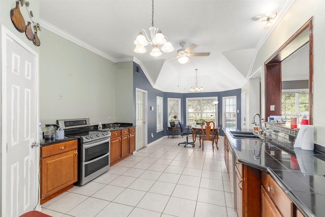 16004 Penick Rd, Waller, TX 77484 - kitchen featuring range with two ovens, a chandelier, ornamental molding, dark countertops, and brown cabinetry