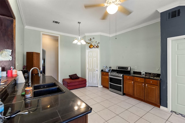 16004 Penick Rd, Waller, TX 77484 - kitchen featuring range with two ovens, dark countertops, ornamental molding, light tile patterned floors, and ceiling fan