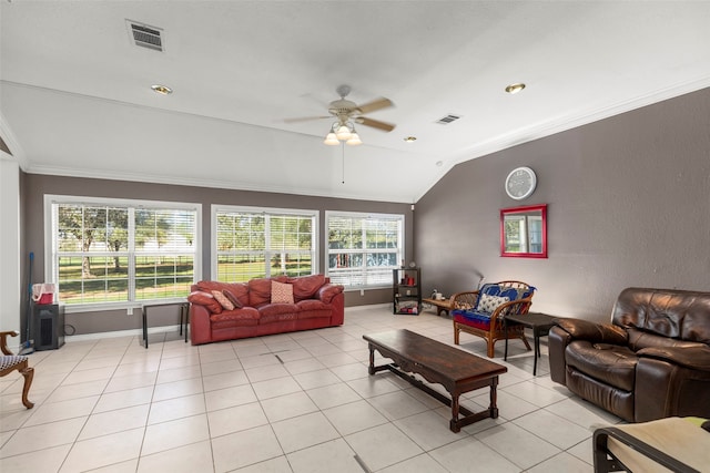 living room featuring plenty of natural light, ceiling fan, light tile patterned floors, and vaulted ceiling