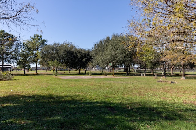 surrounding community featuring a yard and a rural view