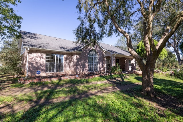 ranch-style home with a front lawn