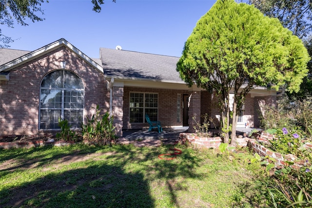 16004 Penick Rd, Waller, TX 77484 - view of front of house featuring brick siding, a shingled roof, and a front yard