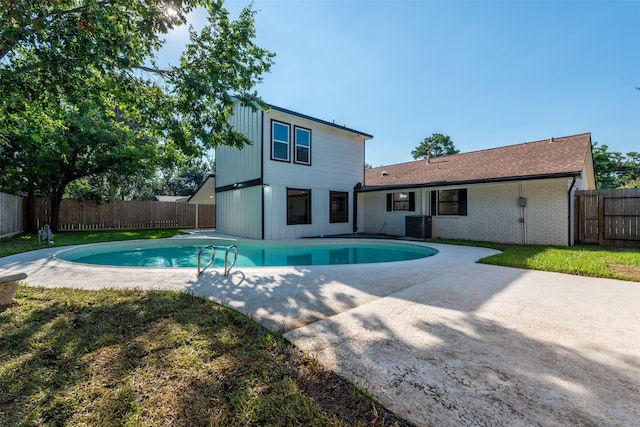 view of swimming pool featuring a patio area and central AC unit