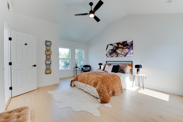 bedroom with light hardwood / wood-style floors, ceiling fan, and lofted ceiling