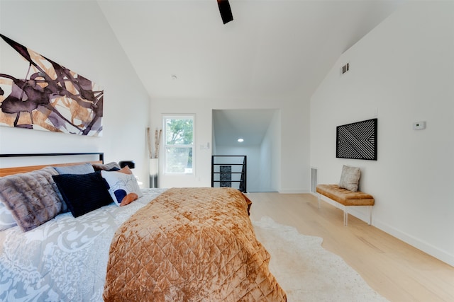 bedroom featuring ceiling fan, light hardwood / wood-style floors, and vaulted ceiling