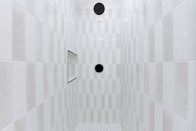 interior details featuring a tile shower