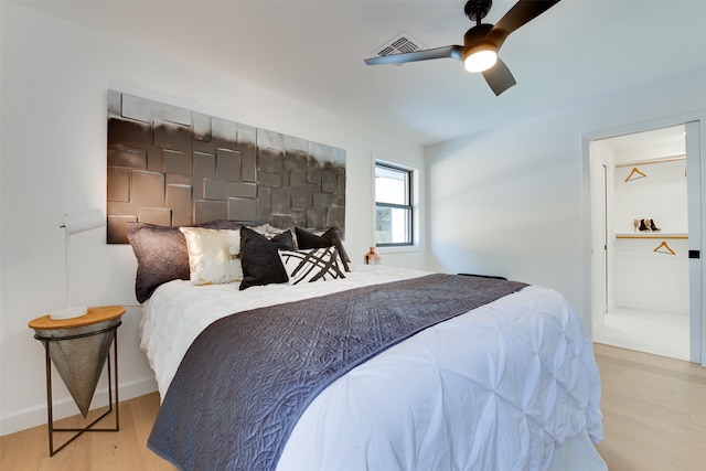 bedroom with ceiling fan and light wood-type flooring