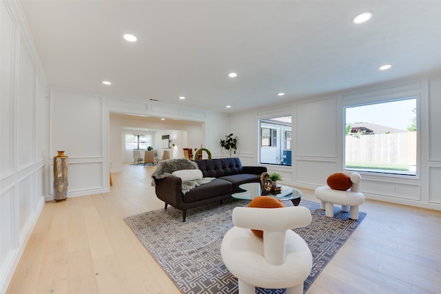 living room with a healthy amount of sunlight and light hardwood / wood-style flooring