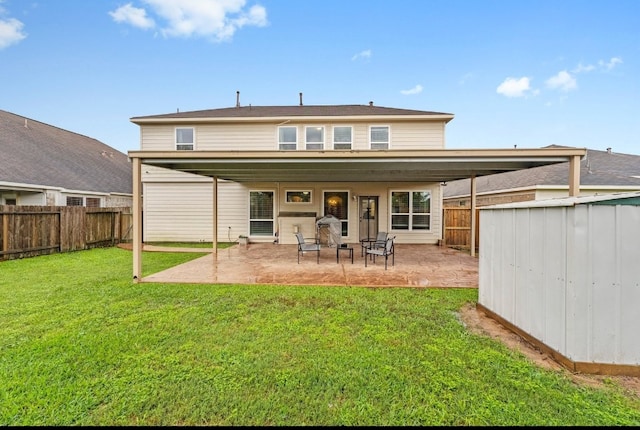 back of property with a yard and a patio